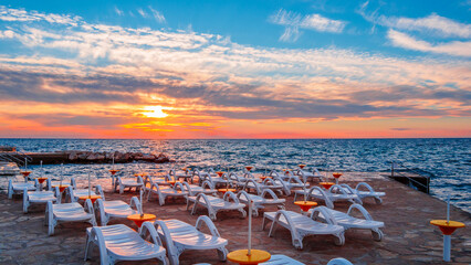 Wall Mural - Sunset on the beach with clouds