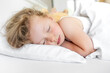 © Tanya Rozhnovskaya - The child sleeps peacefully in his bed.