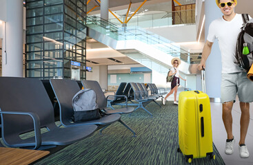 Poster - Happy man and woman with suitcases in waiting area at airport