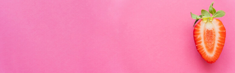 Canvas Print - Top view of natural cut strawberry on pink background, banner.