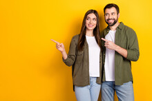 Photo Of Two Positive Friendly People Indicate Finger Empty Space Isolated On Yellow Color Background