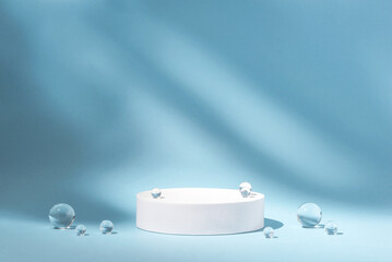 White podium with glass balls on a blue background.