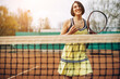 © Petro - Woman playing tennis at the court