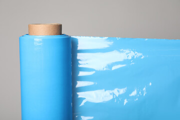 Canvas Print - Roll of turquoise stretch wrap on grey background, closeup