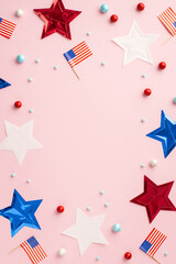 Wall Mural - Fourth of July concept. Top view vertical photo of US national flags stars and scattered candies on isolated pastel pink background with empty space in the middle