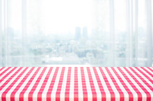 Red Tablecloth On Wood With Blur Home Window Background.
