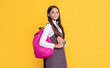 © be free - positive child with school bag on yellow background