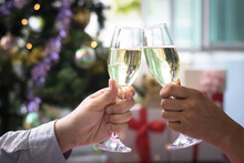 Christmas Party Drinking Concept, Glass Of Champagne With Gift Box On Bokeh Background .