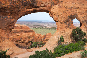 Wall Mural - View through Partition arch in Arches National Park, Utah, USA. Natural sandstone arch formation created by erosion. Famous natural monument in the American southwest. Beautiful sunny day of spring.