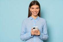 Confident Smiling Businesswoman With Smartphone Chatting With Partners Online Isolated On Blue