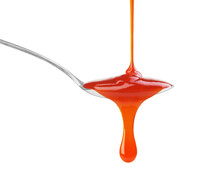 Drip Of Red Sauce In A Spoon On A White Background