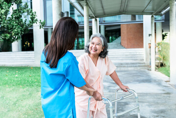 Wall Mural - Asian elderly woman patient happy and smile, while doctor holding hands, encouraged and supported to her, Which holds a cane, do physical therapy to walk, concept to  health care and osteoarthritis.