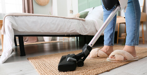 Sticker - Woman vacuuming wicker rug in bedroom