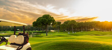 Golf Cart On Beautiful Golf Course At Sunset