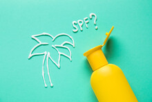 Drawing Of Palm Tree And Question SPF? Made With Sunscreen Cream On Color Background
