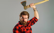 Canadian lumberjack in plaid shirt with axe. Logger tools. Bearded man with hatchet. Cutting wood.