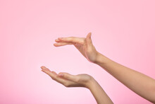 Woman's Hand On Pink Background. Female Hands With Air Between, Ready For Product Placement Concept. Skin And Body Care Concept.