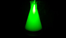 Erlenmeyer Flask Full Of Green Smoke After Chemical Reaction. Background Picture.