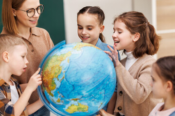 Wall Mural - Teacher and kids during geography lesson