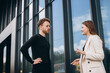 © dsheremeta - Businessman and woman walking and talking outside office