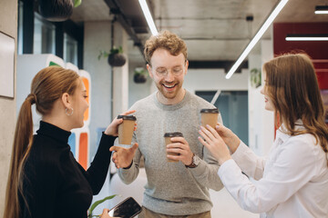 Group of coworkers taking a coffee break at the office