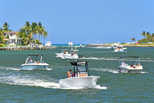 Boats Battle Against The Current Of The Outgoing Tide In The River Channel At Jupiter Inlet, Florida