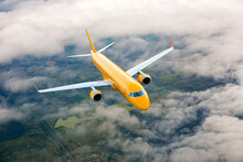 Orange Passenger Aircraft In Flight. The Orange Plane Flies High Above The Clouds. Front View.