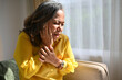 © bongkarn - Asian aged woman touches cheek suffering from sudden tooth pain. Dental illness concept