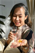 © bongkarn - Portrait of a beautiful asian aged lady drinking water, taking vitamin