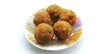 Traditional indian, pakistani and bangladesh festival party sugary ball sweets laddu also known as laddoo, ladoo, lado, meetha or mithai dessert in plate isolated on white background and copy space.