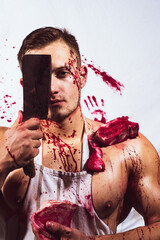 Fototapeta brutal butcher. shirtless butcher with wearing bloody apron posing with fresh raw meat.