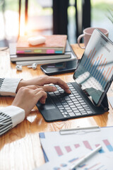 Wall Mural - Cropped shot of businesswoman working at her desk in the office checking and analysing report. Young business woman working on paperwork and statistics