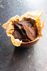 Canvas Print - Beef jerky meat. Dried sliced meat in bowl.