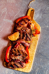 Poster - grilled pork with vegetables on wooden board