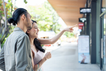 Wall Mural - Asian young man and woman shopping goods outdoors in department store.	