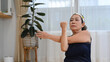 © Prathankarnpap - Shot of active senior lady doing stretching exercises during home workout. Healthy lifestyle concept