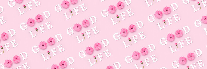 Wall Mural - Good life. Creative banner made with motivational quotes from white letters and beauty natural flowers on pink background