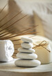 Sea stones balance on wooden table, candle and towel, spa and relax concept, free space for text, selective focus banner