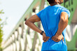 © Home-stock - Sports injury. Young sportsman suffers from lower back pain while exercising