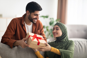 Wall Mural - Middle Eastern Husband Giving Present Box Congratulating Wife At Home