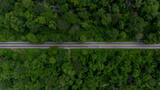 Fototapeta Uliczki - Aerial top view of the the road, Aerial view tropical rain forest with asphalt road cutting through, Road through the green forest Ecosystem and healthy environment background.