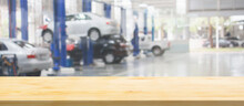 Empty Wood Table Top With Car Service Centre Auto Repair Workshop Blurred Background