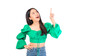 © Png - Video - Photo - Attractive beautiful positive happy smile asian woman hands point up and pose with empty space wearing green shirt and jeans.