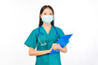 © Png - Video - Photo - Portrait of professional confident young asian female smiling doctor in green scrubs holding clipboard, protection flu cold facial mask  Self-isolation, social distancing.