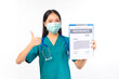 © Png - Video - Photo - Portrait of professional asian female smiling doctor in green scrubs pointing fingers to clipboard health insurance Self-isolation, social distancing.