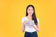 © Png - Video - Photo - US dollars money in hand, happy pretty asian female showing a lot money in her hands winner successful in business bankruptcy economic financial concept.