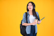 © Png - Video - Photo - Portrait Cheerful young asian female student with backpack holding books education back to school and lifestyle concept yellow background.