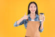 © Png - Video - Photo - pretty asian female smile coffee freelancer open coffee shop show present and poing to coffee paper cup small business and startup concept yellow background.