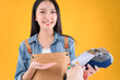 © Png - Video - Photo - pretty asian female smile coffee freelancer own coffee bar shop hold coffee paper cup and payment with a credit card through terminal money swiping a credit card in her own shop yellow background.