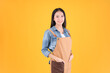 © Png - Video - Photo - pretty asian female smile coffee freelancer own shop ands point up and pose to copy space yellow background.